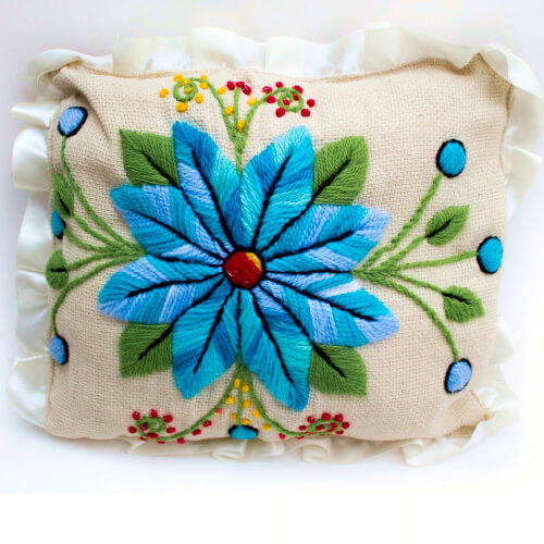 Front view of the embroidered pillow we have for sale. It is made of jute and filled with felt.